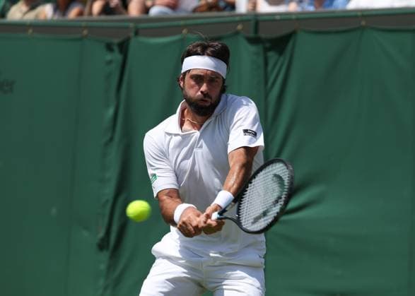 1st July 2025; All England Lawn Tennis and Croquet Club, London, England; Wimbledon Tennis Tournament, Day 2; Nikoloz Basilashvili (GRO) with a backhand shot to Lorenzo Musetti (ITA)  ActionPlus12807396 JohnxPatrickxFletcher