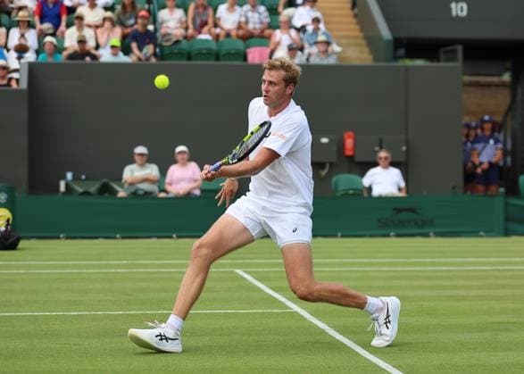 1st July 2025; All England Lawn Tennis and Croquet Club, London, England; Wimbledon Tennis Tournament, Day 2; Johannus Monday (GBR) with a forehand shot to Tommy Paul (USA)  ActionPlus12807419 JohnxPatrickxFletcher