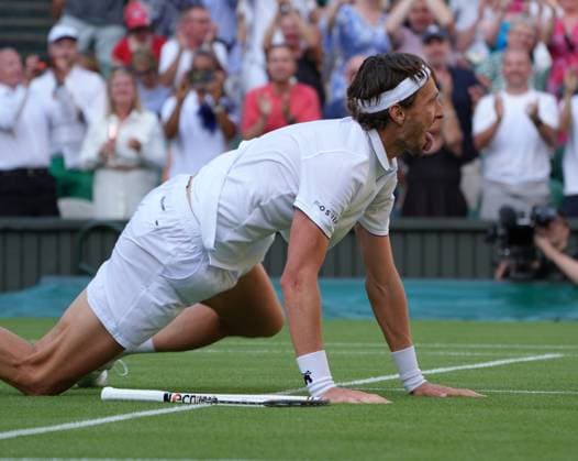 Tennis - 2025 Wimbledon Championships - Men™s Singles - Round One - Alexander Zverev v Arthur Rinderknech All England Lawn Tennis & Croquet Club - Tuesday 1st July 2025 Arthur Rinderknech of FRA drops to his knees after winning match point 