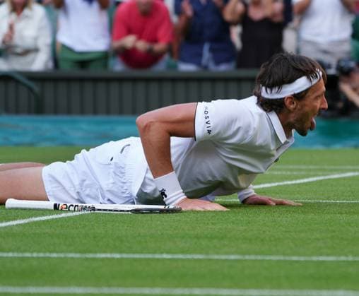 Tennis - 2025 Wimbledon Championships - Men™s Singles - Round One - Alexander Zverev v Arthur Rinderknech All England Lawn Tennis & Croquet Club - Tuesday 1st July 2025 Arthur Rinderknech of FRA drops to his knees after winning match point 