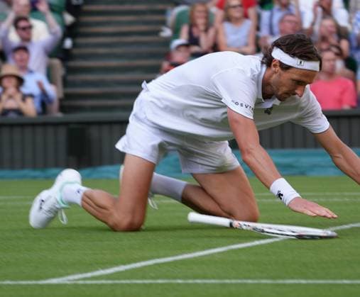 Tennis - 2025 Wimbledon Championships - Men™s Singles - Round One - Alexander Zverev v Arthur Rinderknech All England Lawn Tennis & Croquet Club - Tuesday 1st July 2025 Arthur Rinderknech of FRA drops to his knees after winning match point 