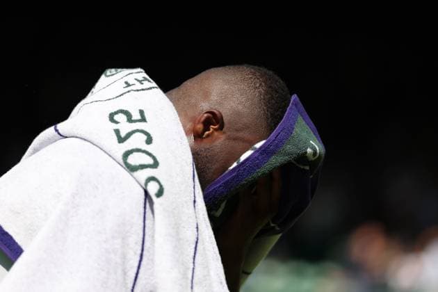 2nd July 2025; All England Lawn Tennis and Croquet Club, London, England; Wimbledon Tennis Tournament, Day 3; A dejected Frances Tiafoe (FRA) hides his face under a Wimbledon towel as he walks out of Court Number One after losing to Cameron Norrie (GBR) by three sets to one  ActionPlus12807953 JohnxPatrickxFletcher