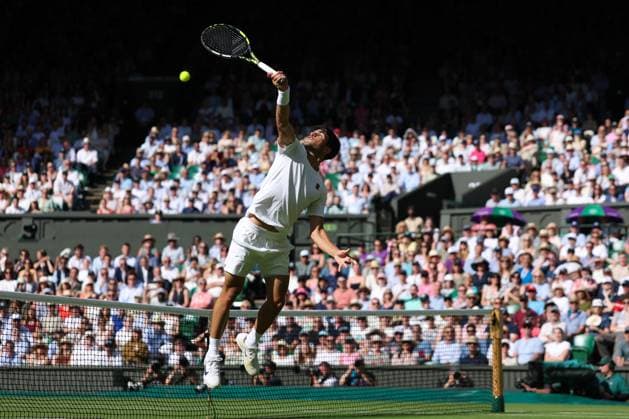 2nd July 2025; All England Lawn Tennis and Croquet Club, London, England; Wimbledon Tennis Tournament, Day 3; Defending Wimbledon Champion Carlos Alcaraz (ESP) leaps in the air to play a backhand shot at the net to win a vital game against Oliver Tarvet (GBR)  ActionPlus12807972 JohnxPatrickxFletcher