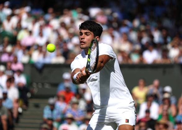 2nd July 2025; All England Lawn Tennis and Croquet Club, London, England; Wimbledon Tennis Tournament, Day 3; Carlos Alcaraz (ESP) with a backhand shot to Oliver Tarvet (GBR)  ActionPlus12807987 JohnxPatrickxFletcher