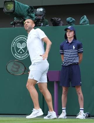 Tennis - 2025 Wimbledon Championships - Men™s Singles - 2nd round - Dan Evans v Novak Djokovic All England Lawn Tennis & Croquet Club - Thursday 3rd July 2025 Dan Evans of GBR watches with the ball boy 