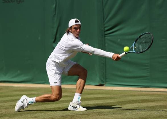 3rd July 2025; All England Lawn Tennis and Croquet Club, London, England; Wimbledon Tennis Tournament, Day 4; Arthur Cazaux (FRA) with a backhand shot to Alex de Minaur (AUS)  ActionPlus12808112 JohnxPatrickxFletcher