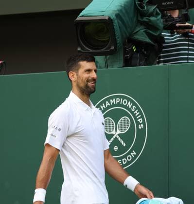 Serbian Novak Djokovic smiles in his second round match against Great Britain s Dan Evans on day four of the 2025 Wimbledon Championships in London on Thurs, June 03, 2025.  LON2025070320 HUGOxPHILPOTT