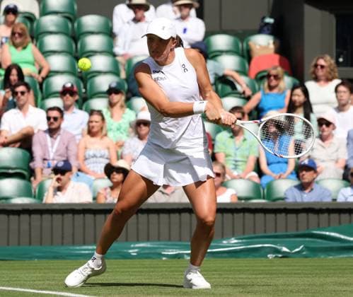 Poland s Iga Swiatek plays a backhand in her second round match against American Caty Mcnally on day four of the 2025 Wimbledon Championships in London on Thursday, June 03, 2025.  LON2025070326 HUGOxPHILPOTT