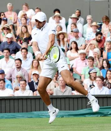 Australia s Aleksandar Vukic plays a backhand in his second round match against Italian Jannik Sinner on day four of the 2025 Wimbledon Championships in London on Thursday, June 03, 2025.  LON2025070355 HUGOxPHILPOTT