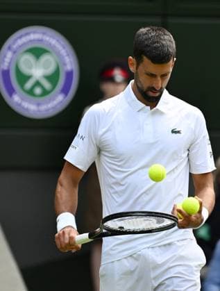 (250704) -- LONDON, July 4, 2025 -- Novak Djokovic prepares to serve during the men s singles second round match between Novak Djokovic of Serbia and Daniel Evans of Britain at the Wimbledon Tennis Championships in London, Britain, July 3, 2025. ) (SP)BRITAIN-LONDON-TENNIS-WIMBLEDON-MEN S SINGLES ZhaoxDingzhe 