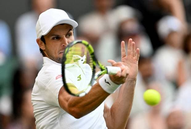 (250704) -- LONDON, July 4, 2025 -- Aleksandar Vukic hits a return during the men s singles second round match between Jannik Sinner of Italy and Aleksandar Vukic of Australia at the Wimbledon Tennis Championships in London, Britain, July 3, 2025. ) (SP)BRITAIN-LONDON-TENNIS-WIMBLEDON-MEN S SINGLES LixYing 