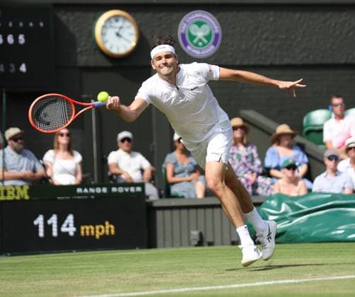 American Taylor Fritz plays a forehand in his third round match against Spain s Alejandro Davidovich Fokina on day five of the 2025 Wimbledon Championships in London on Friday, July 04, 2025.  LON20250704456 HUGOxPHILPOTT