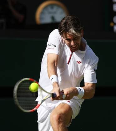 Great Britain s Cameron Norrie plays a backhand in his third round match against Italian Mattia Bellucci on day five of the 2025 Wimbledon Championships in London on Friday, July 04, 2025.  LON2025070456 HUGOxPHILPOTT