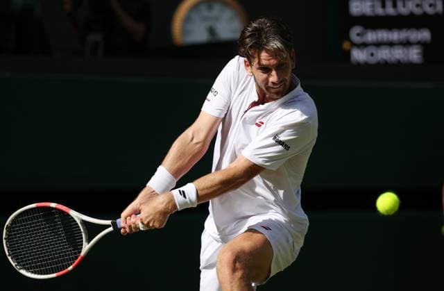 Great Britain s Cameron Norrie plays a backhand in his third round match against Italian Mattia Bellucci on day five of the 2025 Wimbledon Championships in London on Friday, July 04, 2025.  LON2025070462 HUGOxPHILPOTT