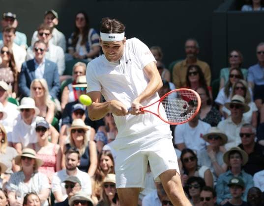 American Taylor Fritz plays a backhand in his third round match against Spain s Alejandro Davidovich Fokina on day five of the 2025 Wimbledon Championships in London on Friday, July 04, 2025.  LON2025070472 HUGOxPHILPOTT