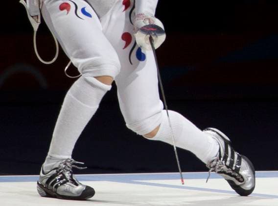 August 2, 2012 - London, England, United Kingdom - Korean fencer s knees bend low during medal match. Copyright: xDanxAndersonx