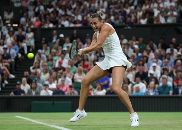4th July 2025; All England Lawn Tennis and Croquet Club, London, England; Wimbledon Tennis Tournament, Day 5; Aryna Sabalenka (BLR) with a backhand shot to Emma Raducanu (GBR)  ActionPlus12809206 JohnxPatrickxFletcher