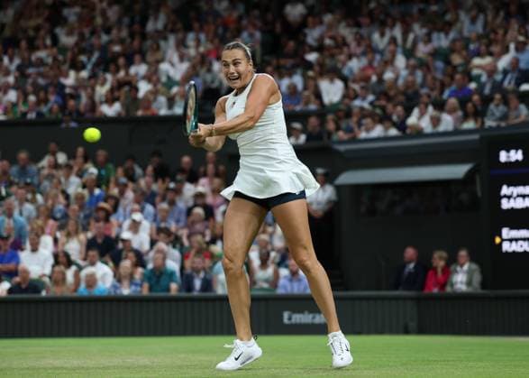 4th July 2025; All England Lawn Tennis and Croquet Club, London, England; Wimbledon Tennis Tournament, Day 5; Aryna Sabalenka (BLR) with a backhand shot to Emma Raducanu (GBR)  ActionPlus12809208 JohnxPatrickxFletcher
