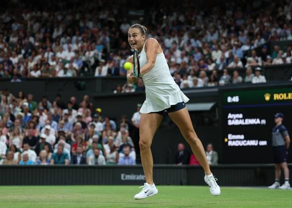 4th July 2025; All England Lawn Tennis and Croquet Club, London, England; Wimbledon Tennis Tournament, Day 5; Aryna Sabalenka (BLR) with a backhand shot to Emma Raducanu (GBR)  ActionPlus12809210 JohnxPatrickxFletcher
