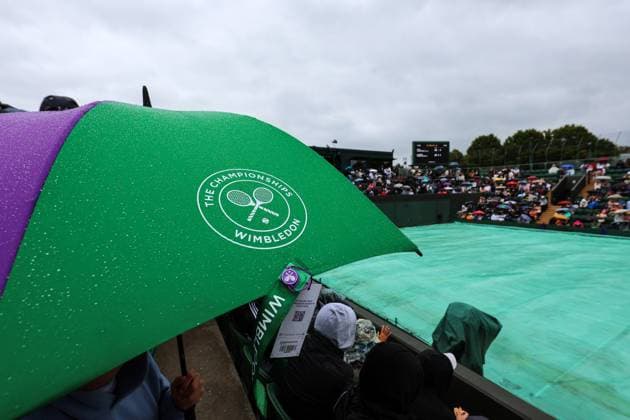 5th July 2025; All England Lawn Tennis and Croquet Club, London, England; Wimbledon Tennis Tournament, Day 6; Heavy rain delays play on all courts as spectators hide under umbrellas  ActionPlus12809284 JohnxPatrickxFletcher