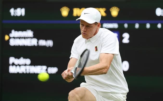 Italian Jannik Sinner plays a backhand in his third round match against Spain s Pedro Martinez on day six of the 2025 Wimbledon Championships in London on Saturday, July 05, 2025.  LON2025070507 HUGOxPHILPOTT