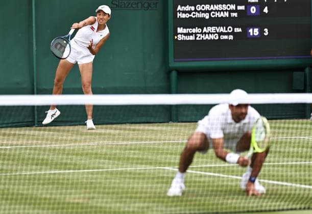 LONDON, ENGLAND - JULY 05: Zhang Shuai of China and Marcelo Arevalo of El Salvador compete against Andre Goransson of Sweden and Chan Hao-Ching of Chinese Taipei during the Mixed Doubles First Round match on day six of 2025 Wimbledon Championships at All England Lawn Tennis and Croquet Club on July 4, 2025 in London, England.  Copyright: xVCGx 111577864289