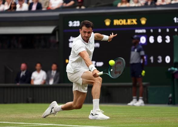 5th July 2025; All England Lawn Tennis and Croquet Club, London, England; Wimbledon Tennis Tournament, Day 6; Pedro Martinez (ESP) with a backhand shot to Jannik Sinner (ITA)  ActionPlus12809699 JohnxPatrickxFletcher