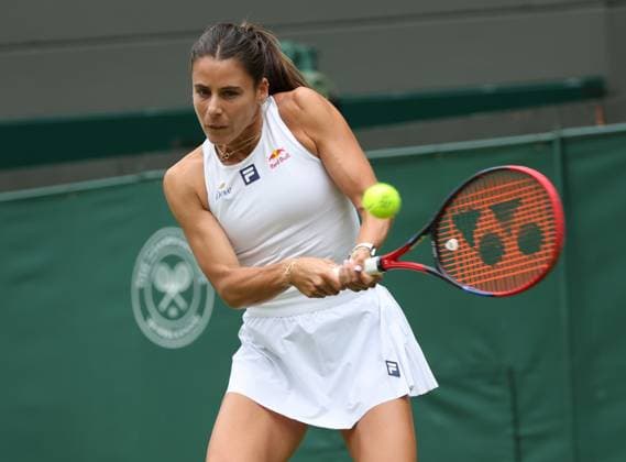 USA s Emma Navarro plays a backhand in her third round match against Czech Barbora Krejcikova on day six of the 2025 Wimbledon Championships in London on Saturday, July 05, 2025.  LON2025070534 HUGOxPHILPOTT