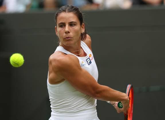 USA s Emma Navarro plays a backhand in her third round match against Czech Barbora Krejcikova on day six of the 2025 Wimbledon Championships in London on Saturday, July 05, 2025.  LON2025070549 HUGOxPHILPOTT