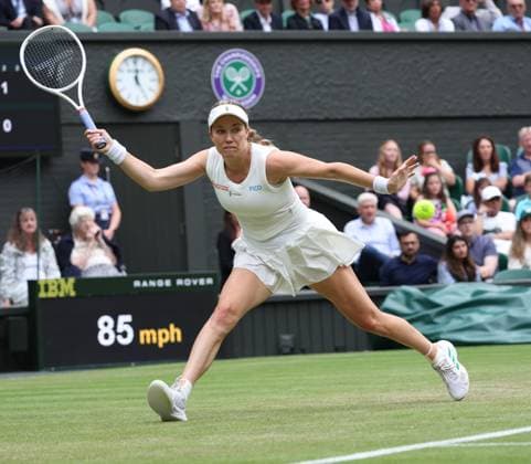 USA s Danielle Collins plays a forehand in her third round match against Poland s Iga Swiatek on day six of the 2025 Wimbledon Championships in London on Saturday, July 05, 2025.  LON2025070564 HUGOxPHILPOTT