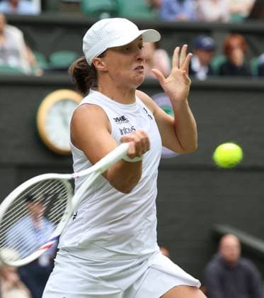 Poland s Iga Swiatek plays a forehand in her third round match against USA s Danielle Collins on day six of the 2025 Wimbledon Championships in London on Saturday, July 05, 2025.  LON2025070566 HUGOxPHILPOTT