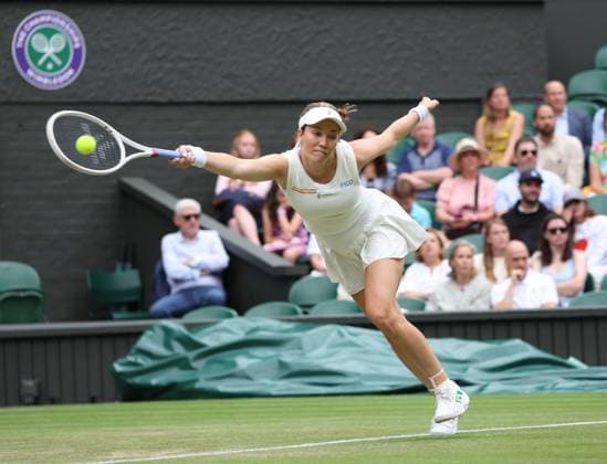 USA s Danielle Collins plays a forehand in her third round match against Poland s Iga Swiatek on day six of the 2025 Wimbledon Championships in London on Saturday, July 05, 2025.  LON2025070579 HUGOxPHILPOTT
