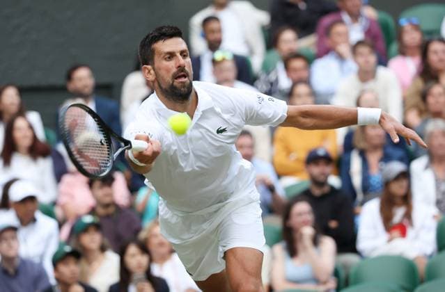 Serbian Novak Djokovic plays a forehand in his third round match against Serbian Miomir Kecmanovic on day six of the 2025 Wimbledon Championships in London on Saturday, July 05, 2025.  LON20250705107 HUGOxPHILPOTT