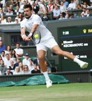 Serbian Novak Djokovic plays a backhand in his third round match against Serbian Miomir Kecmanovic on day six of the 2025 Wimbledon Championships in London on Saturday, July 05, 2025.  LON2025070598 HUGOxPHILPOTT