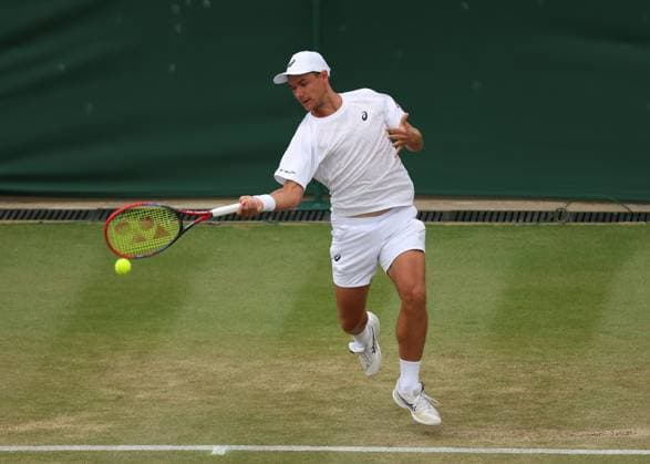 6th July 2025; All England Lawn Tennis and Croquet Club, London, England; Wimbledon Tennis Tournament, Day 7; Kamil Majchrzak (POL) with a forehand shot to Karen Khachanov (RUS)  ActionPlus12810497 JohnxPatrickxFletcher