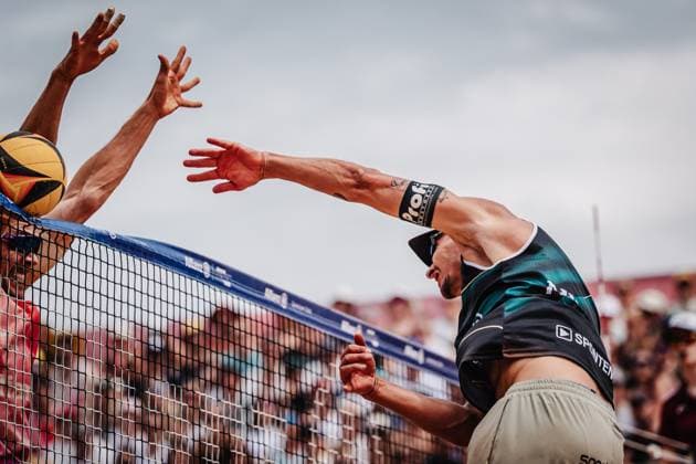 Beach volleyball men Allianz German Beach Tour 2025 Tourstop Munich 06 07 2025 Right Mathias Seiser attacking against David Poniewaz Munich Central University Sports Munich Bavaria Germany