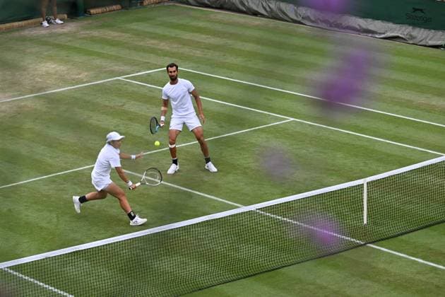 (250707) -- LONDON, July 7, 2025 -- Jiang Xinyu (L) Yuki Bhambri compete during the mixed doubles second round match between Zhang Shuai (China) Marcelo Arevalo (El Salvador) and Jiang Xinyu (China) Yuki Bhambri (India) at the Wimbledon Tennis Championships in London, Britain, July 6, 2025. ) (SP)BRITAIN-LONDON-TENNIS-WIMBLEDON-MIXED DOUBLES ZhaoxDingzhe 
