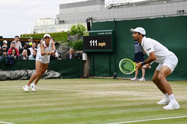 (250707) -- LONDON, July 7, 2025 -- Zhang Shuai (L) Marcelo Arevalo compete during the mixed doubles second round match between Zhang Shuai (China) Marcelo Arevalo (El Salvador) and Jiang Xinyu (China) Yuki Bhambri (India) at the Wimbledon Tennis Championships in London, Britain, July 6, 2025. ) (SP)BRITAIN-LONDON-TENNIS-WIMBLEDON-MIXED DOUBLES ZhaoxDingzhe 