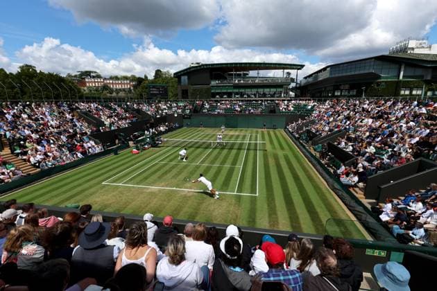 7th July 2025; All England Lawn Tennis and Croquet Club, London, England; Wimbledon Tennis Tournament, Day 8; Guido Andreozzi (ARG) with a backhand shot to Lloyd Glasspool (GBR) on court two during the mens doubles match as dark clouds loom over the All England Lawn Tennis and Croquet Club  ActionPlus12811188 JohnxPatrickxFletcher