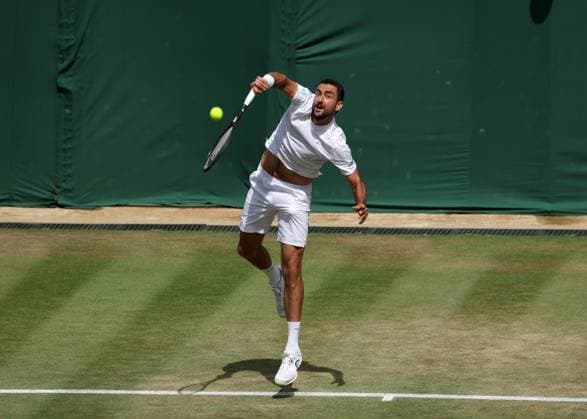 7th July 2025; All England Lawn Tennis and Croquet Club, London, England; Wimbledon Tennis Tournament, Day 8; Marin Cilic (CRO) serves to Flavio Cobolli (ITA)  ActionPlus12811158 JohnxPatrickxFletcher