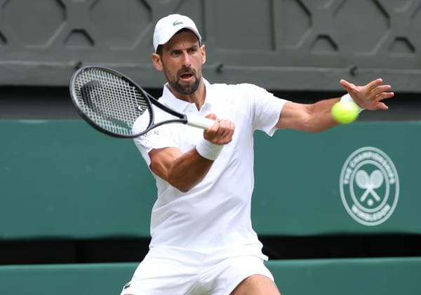 Serbian Novak Djokovic plays a forehand in his fourth round match against Australia s Alex De Minaur on day eight of the 2025 Wimbledon Championships in London on Monday, July 07, 2025.  LON2025070706 HUGOxPHILPOTT