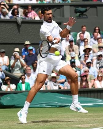 Serbian Novak Djokovic plays a forehand in his fourth round match against Australia s Alex De Minaur on day eight of the 2025 Wimbledon Championships in London on Monday, July 07, 2025.  LON2025070723 HUGOxPHILPOTT