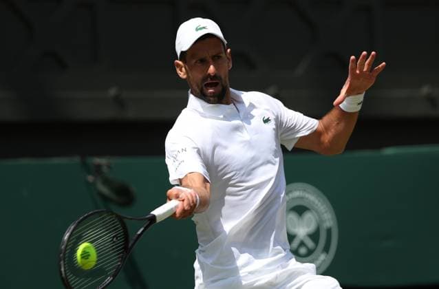 Serbian Novak Djokovic plays a forehand in his fourth round match against Australia s Alex De Minaur on day eight of the 2025 Wimbledon Championships in London on Monday, July 07, 2025.  LON2025070709 HUGOxPHILPOTT