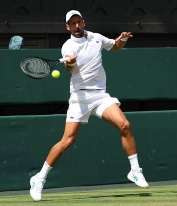 Serbian Novak Djokovic plays a forehand in his fourth round match against Australia s Alex De Minaur on day eight of the 2025 Wimbledon Championships in London on Monday, July 07, 2025.  LON2025070710 HUGOxPHILPOTT