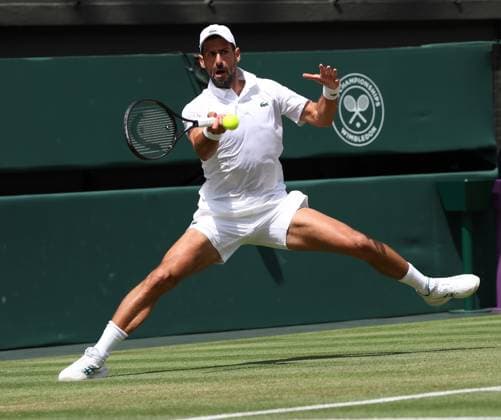 Serbian Novak Djokovic plays a forehand in his fourth round match against Australia s Alex De Minaur on day eight of the 2025 Wimbledon Championships in London on Monday, July 07, 2025.  LON2025070716 HUGOxPHILPOTT