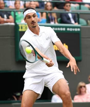 Italian Lorenzo Sonego plays a forehand in his fourth round match against American Ben Shelton on day eight of the 2025 Wimbledon Championships in London on Monday, July 07, 2025.  LON2025070746 HUGOxPHILPOTT