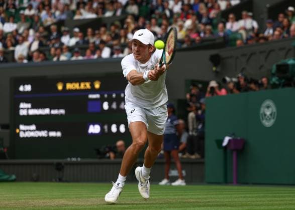 7th July 2025; All England Lawn Tennis and Croquet Club, London, England; Wimbledon Tennis Tournament, Day 8; Alex de Minaur (AUS) with a backhand shot to Novak Djokovic (SRB)  ActionPlus12811242 JohnxPatrickxFletcher