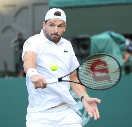 Bulgarian Grigor Dimitrov plays a backhand in his fourth round match against Italian Jannik Sinner on day eight of the 2025 Wimbledon Championships in London on Monday, July 07, 2025.  LON2025070797 HUGOxPHILPOTT