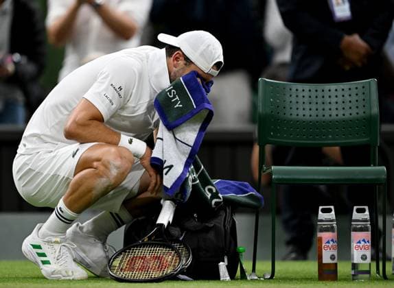 (250708) -- LONDON, July 8, 2025 -- Grigor Dimitrov wipes the tears after getting injured during the men s singles round of 16 match between Grigor Dimitrov of Bulgaria and Jannik Sinner of Italy at the Wimbledon Tennis Championships in London, Britain, July 7, 2025. ) (SP)BRITAIN-LONDON-TENNIS-WIMBLEDON-MEN S SINGLES LixYing 