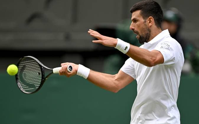 (250708) -- LONDON, July 8, 2025 -- Novak Djokovic hits a return during the men s singles round of 16 match between Novak Djokovic of Serbia and Alex De Minaur of Australia at the Wimbledon Tennis Championships in London, Britain, July 7, 2025. ) (SP)BRITAIN-LONDON-TENNIS-WIMBLEDON-MEN S SINGLES LixYing 